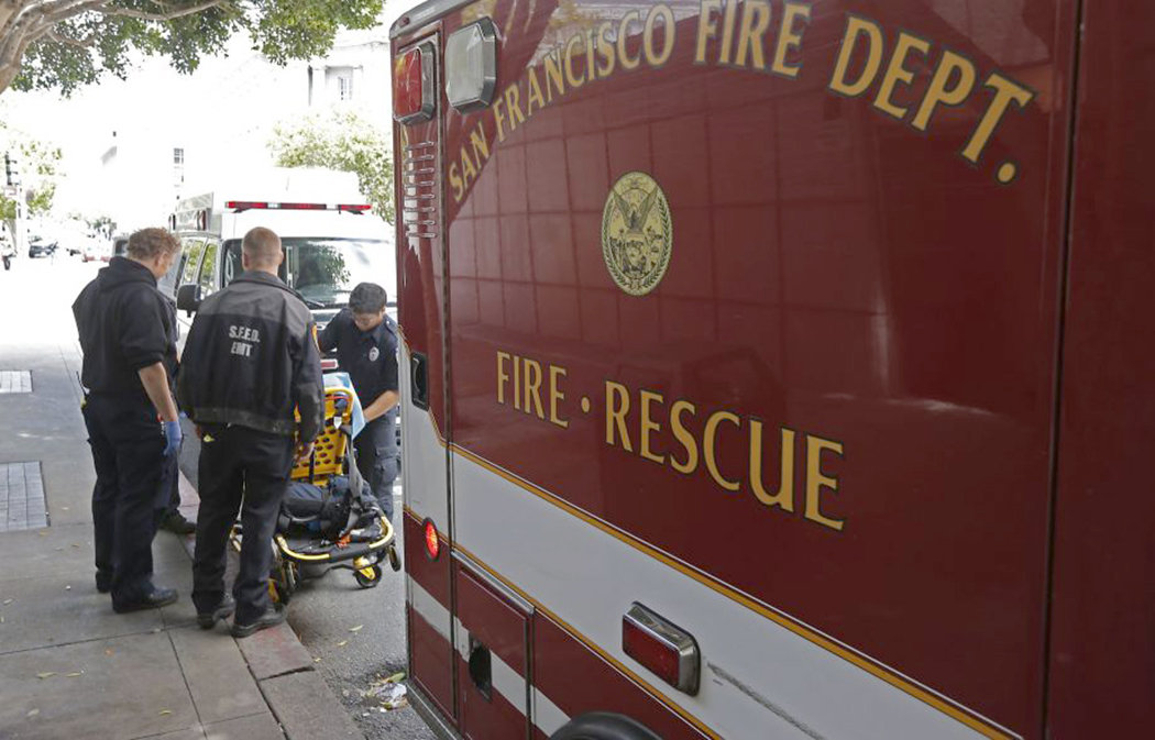 Ambulance staff loading patient into ambulance