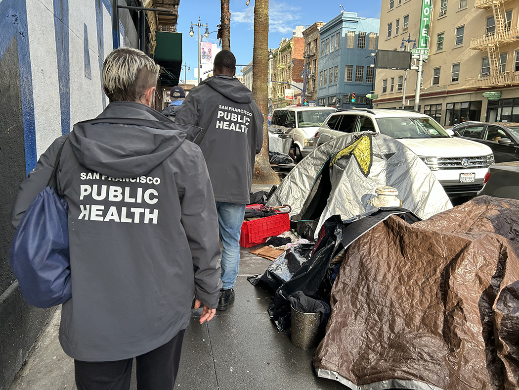 street team walking by tents